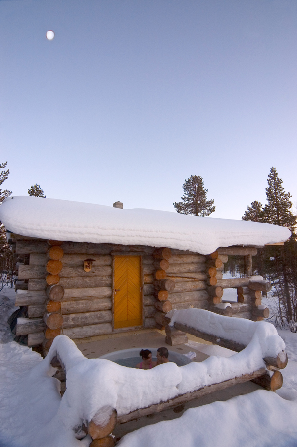 Hot tub outside a log house in winter. SOURCE: Courtesy of Finland Tourist 